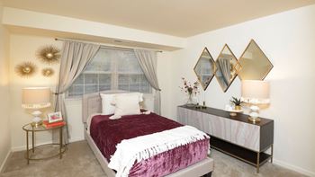bedroom with a bed and a dresser and a window at Village of Pine Run Apartments & Townhomes*, Baltimore